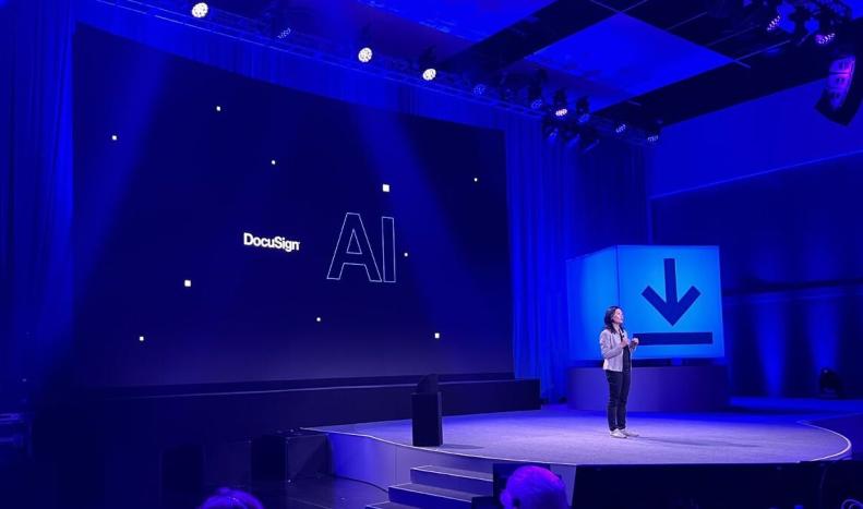 DocuSign chief product officer Inhi Cho Suh on stage at Momentum 2023. Backdrop says "DocuSign AI"