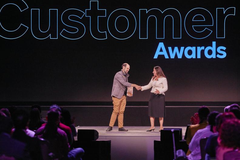 Jonathan Johnson-Swagel accepts a Customer Award for Innovation at Momentum 2023