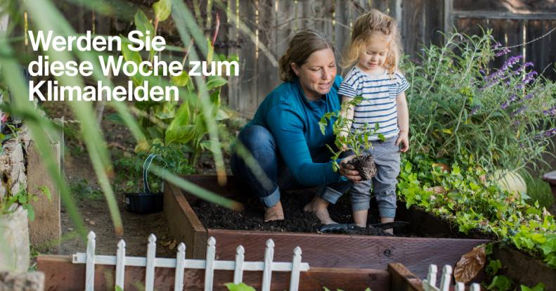Mom with child in a garden, planting someting
