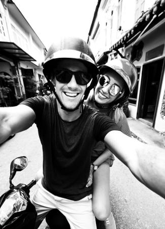 Kayak Hero Image: Man and Woman on a bike smiling 