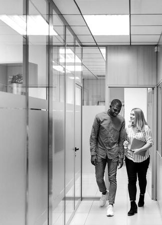 Man and woman walking in office