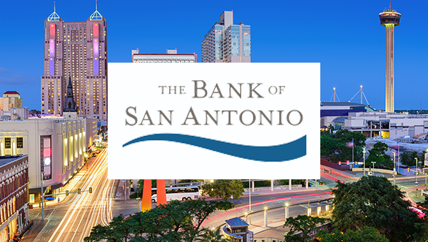 The Bank of San Antonio Logo over the San Antonio skyline at night.