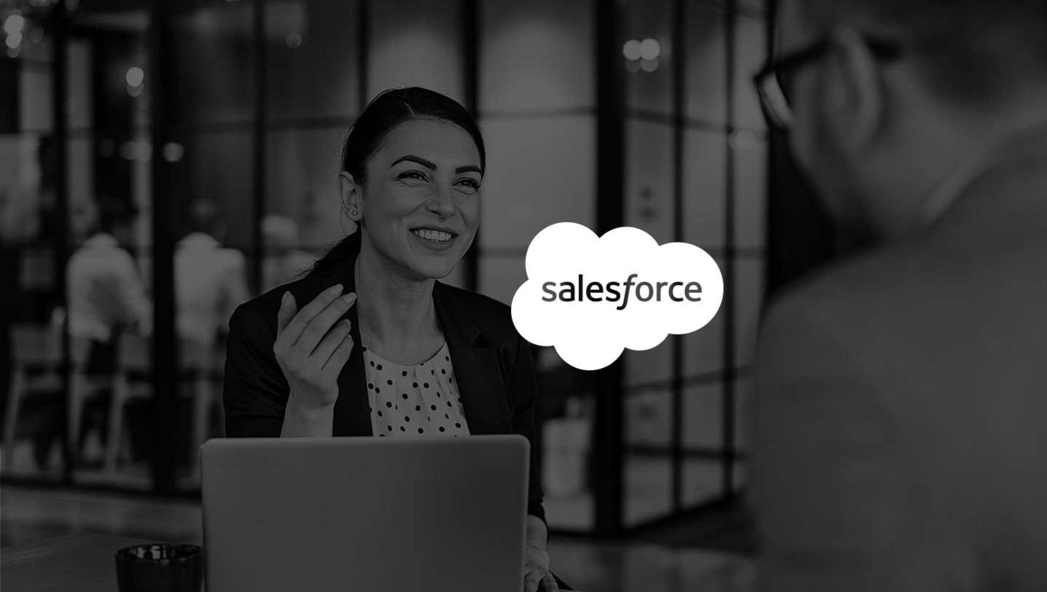 Image of woman smiling in meeting while using Salesforce with DocuSign.