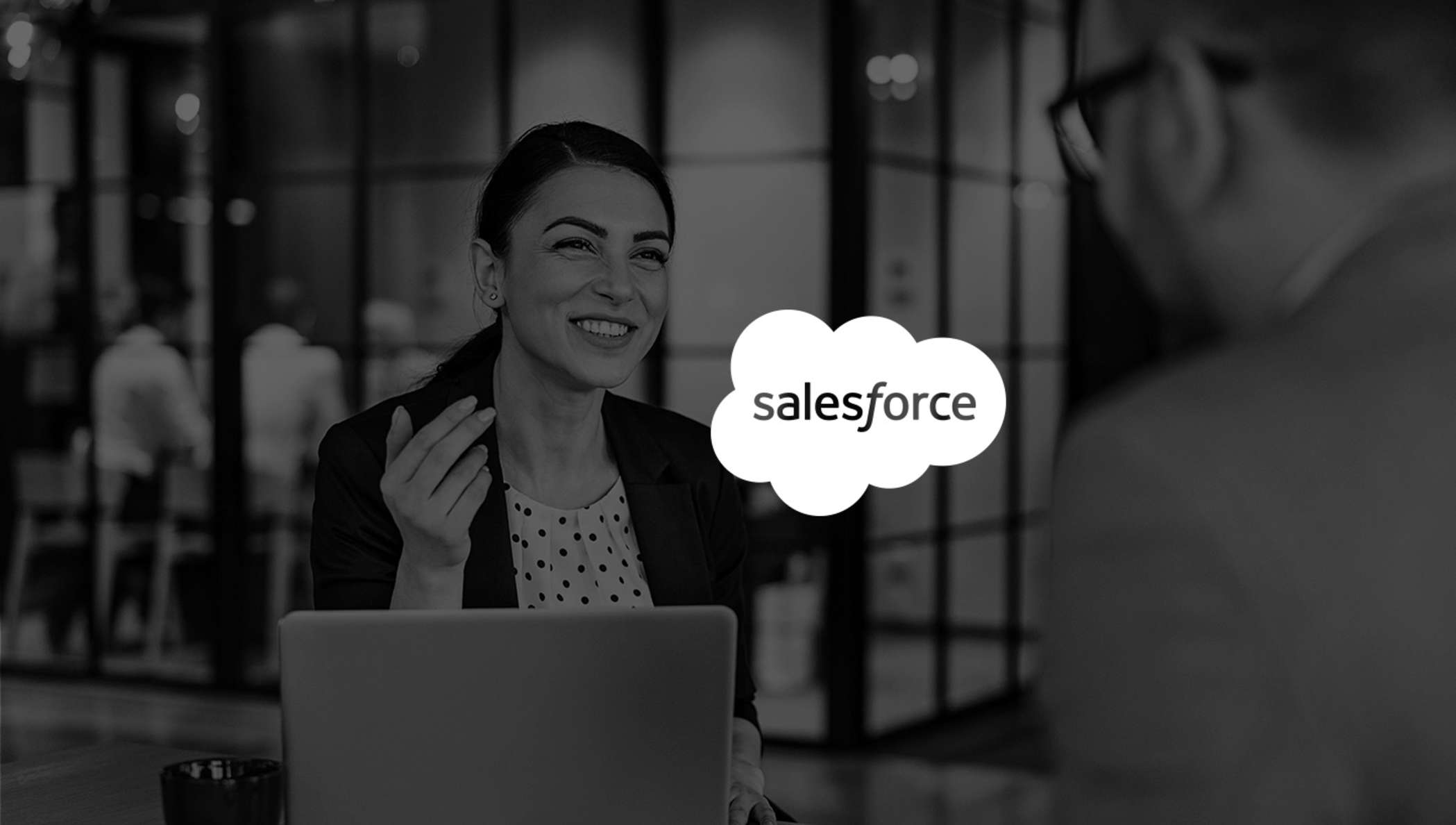 Image of woman smiling in meeting while using Salesforce with DocuSign.